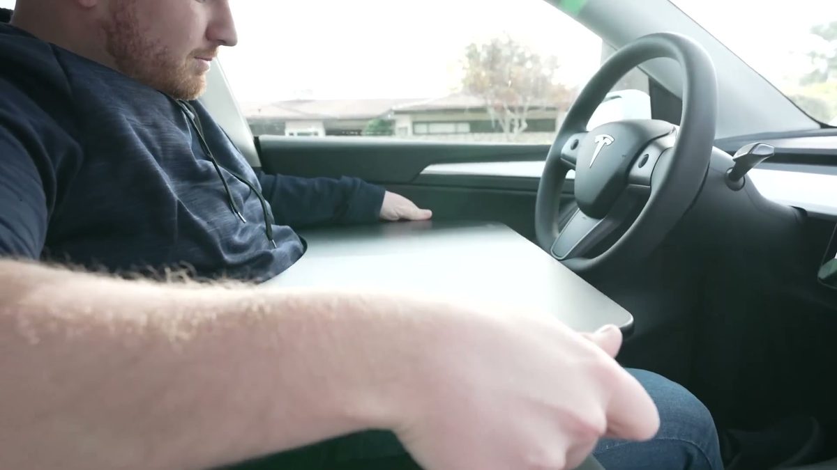 Steering Wheel and Armrest Trays in Ryan Shaw's Tesla